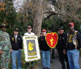 Wolfhound veterans at a memorial ceremony with the 27th Infantry "Nec Aspera Terrent" wreath.